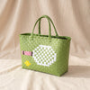 Tennis woven basket bag in green with woven tennis ball motif, by Duggan Society