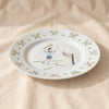 Tennis gentleman dinner plate seen at an angle showing the rim, by Duggan Society