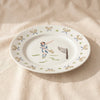 Tennis lady dinner plate seen at an angle showing the rim, by Duggan Society