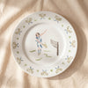 Tennis lady dinner plate with hand painted player and crossed racquet border, by Duggan Society