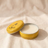 Rose multi-purpose balm tin open with the lid leaning, showing the ivory balm, by Féret Parfumeur