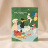 Dog Picnic Birthday Card by Ula Bloom on a natural cotton backdrop