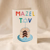 Mazel Cake Card by Mr. Boddington's Studio on a natural cotton backdrop