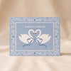 Always and Forever Swans Card by Ula Bloom on a natural cotton backdrop