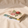 John Derian Everything Roses Notebook Set on a natural cotton backdrop