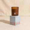 Cowboy scented candle by Nose Dive on a natural cotton backdrop