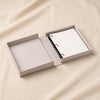 Amour embroidered photo album by Printworks shown open on a natural cotton backdrop