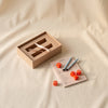 Bazaar Yatzy travel dice game by Printworks on a natural cotton backdrop
