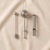 The Essentials tea tools by Printworks tools shown arranged on a natural cotton backdrop