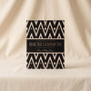 Lacquered backgammon set in black by Printworks closed top view on a natural cotton backdrop