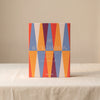 Lacquered backgammon set in red by Printworks with its packaging on a natural cotton backdrop
