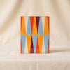 Lacquered backgammon set in red by Printworks closed top view on a natural cotton backdrop