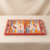 Lacquered backgammon set in red by Printworks shown open flat on a natural cotton backdrop