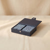 Reverra leather double playing cards by Printworks with the box open on a natural cotton backdrop