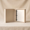 Voyage embroidered photo album by Printworks shown open on a natural cotton backdrop