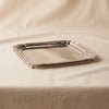 Alsace polished nickel tray by Zodax on a natural cotton backdrop