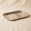 Andrea polished nickel serving tray 16 inch by Zodax on a natural cotton backdrop