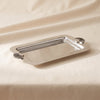 Cap Ferrat fan shell serving tray in polished nickel by Zodax on a natural cotton backdrop