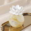 Petals porcelain diffuser in Bergamot and Pink Pepper by Zodax on a natural cotton backdrop