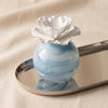 Petals porcelain diffuser in Water Lotus by Zodax alternate view on a natural cotton backdrop
