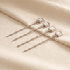 Spiga cocktail pick single by Zodax on a natural cotton backdrop