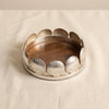 Sur-mer shell wine coaster in polished nickel by Zodax on a natural cotton backdrop